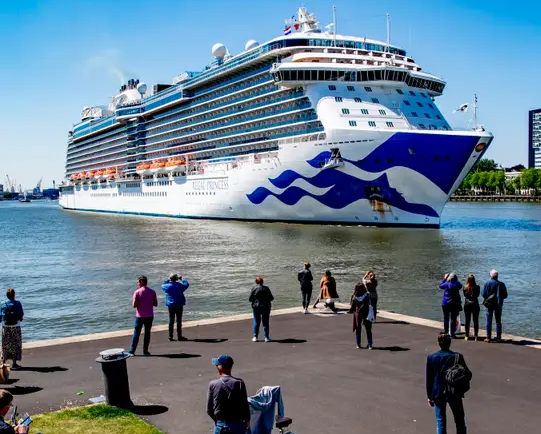 Cruise ship and travelers at a port