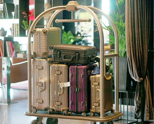 Suitcases on a luggage cart in a hotel lobby